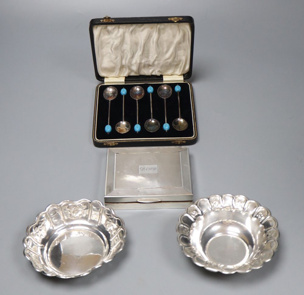 A cased set of six silver bean end coffee spoons, a silver cigarette box and two white metal dishes.